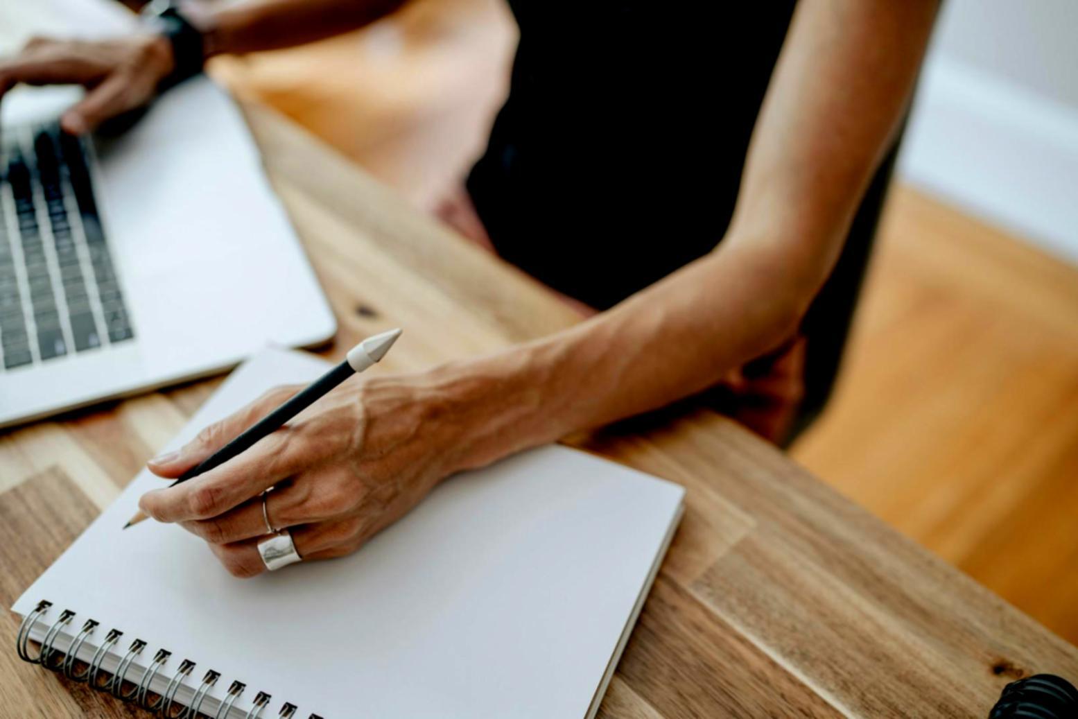 Close-up of weekly expense tracking notebook